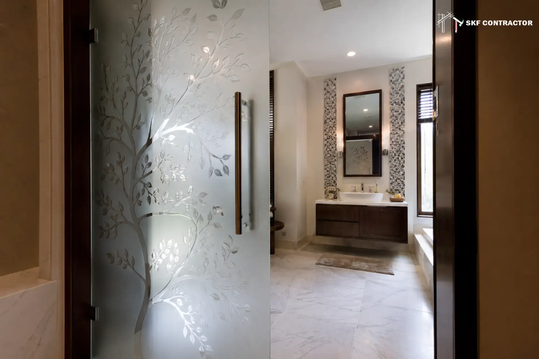 Modern bathroom design featuring a frosted glass door with tree etching and a floating vanity.