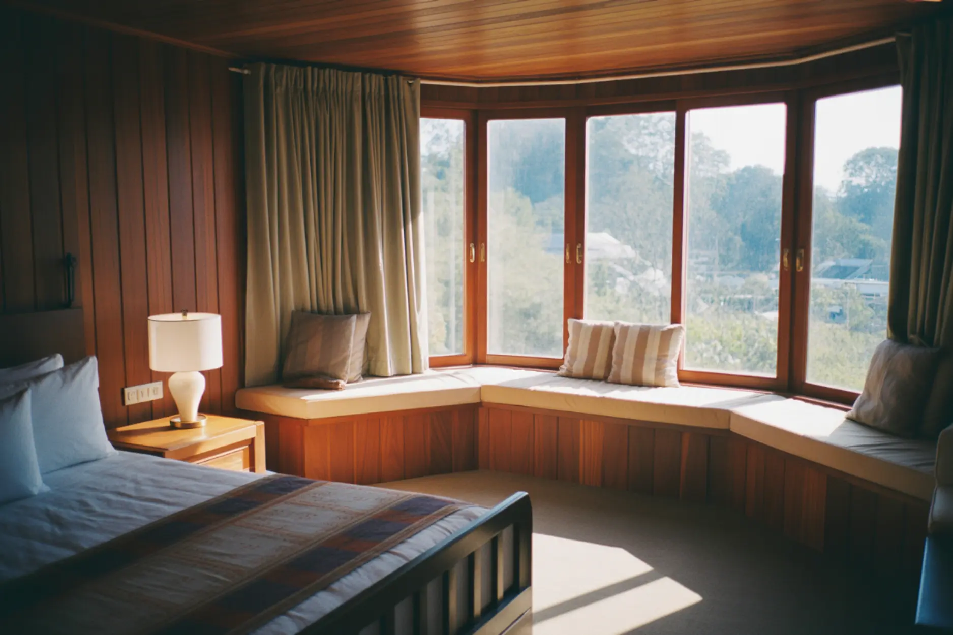 Teak bedroom interiors with a classy window bay seat