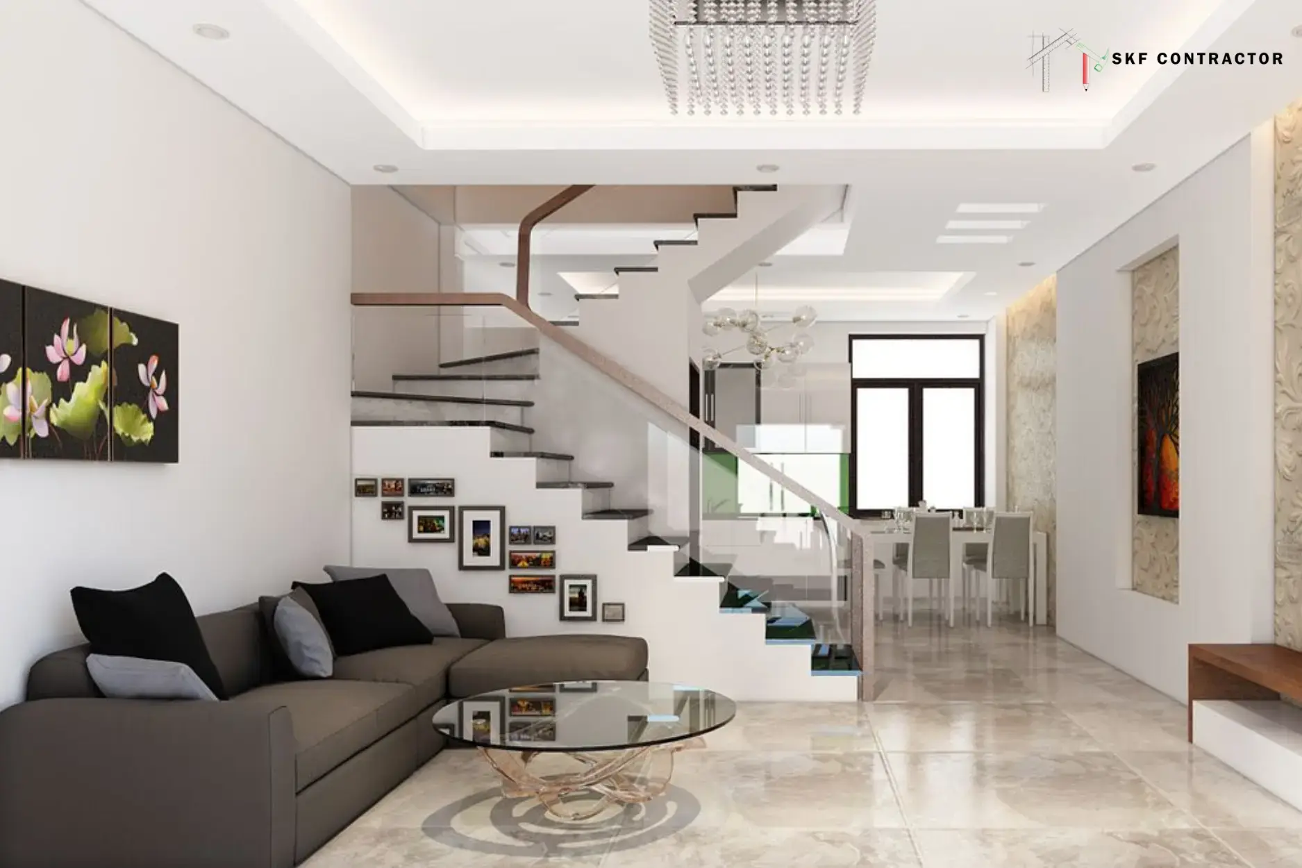 Modern open-concept living room with a dark grey sectional sofa and a sleek white staircase with glass railings.